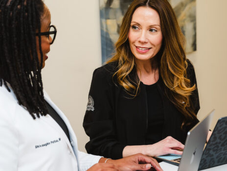 Nurse Practitioner, Shivaughn Petkus, reviewing a patient's chart with her Procedure Nurse at Yoo Direct Health