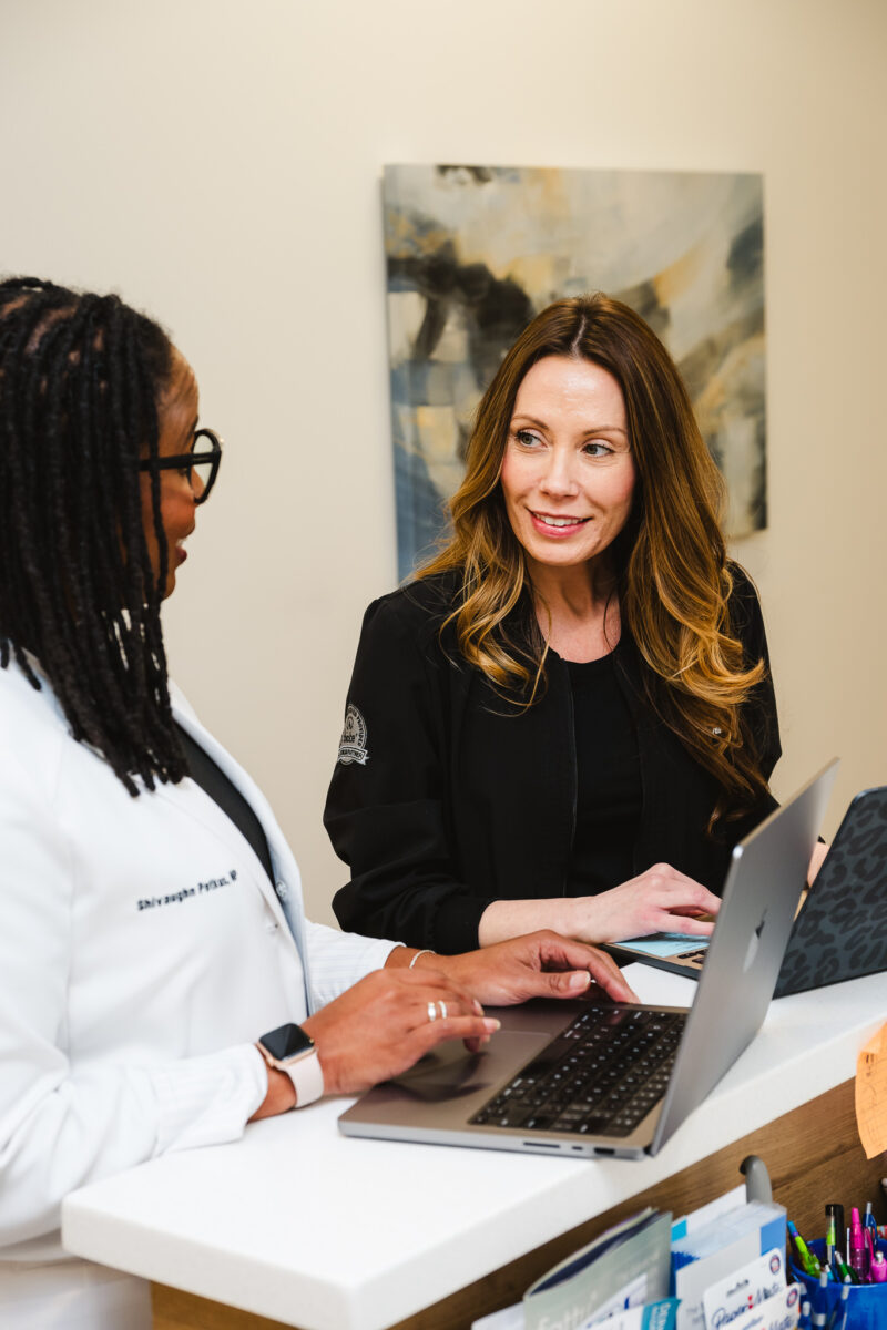 Nurse Practitioner, Shivaughn Petkus, reviewing a patient's chart with her Procedure Nurse at Yoo Direct Health